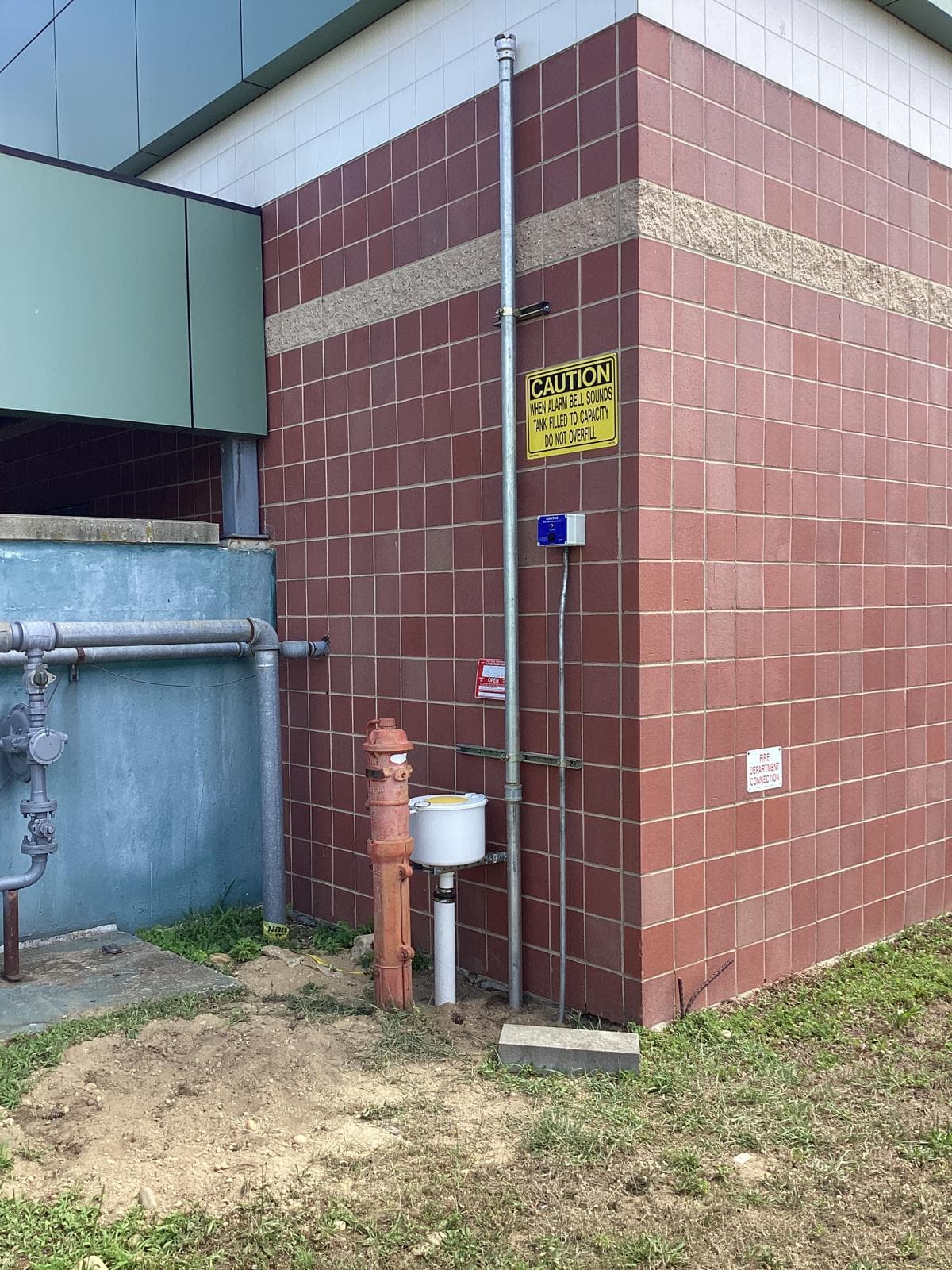 Exterior remote diesel fill connection with high-level alarm and vent riser