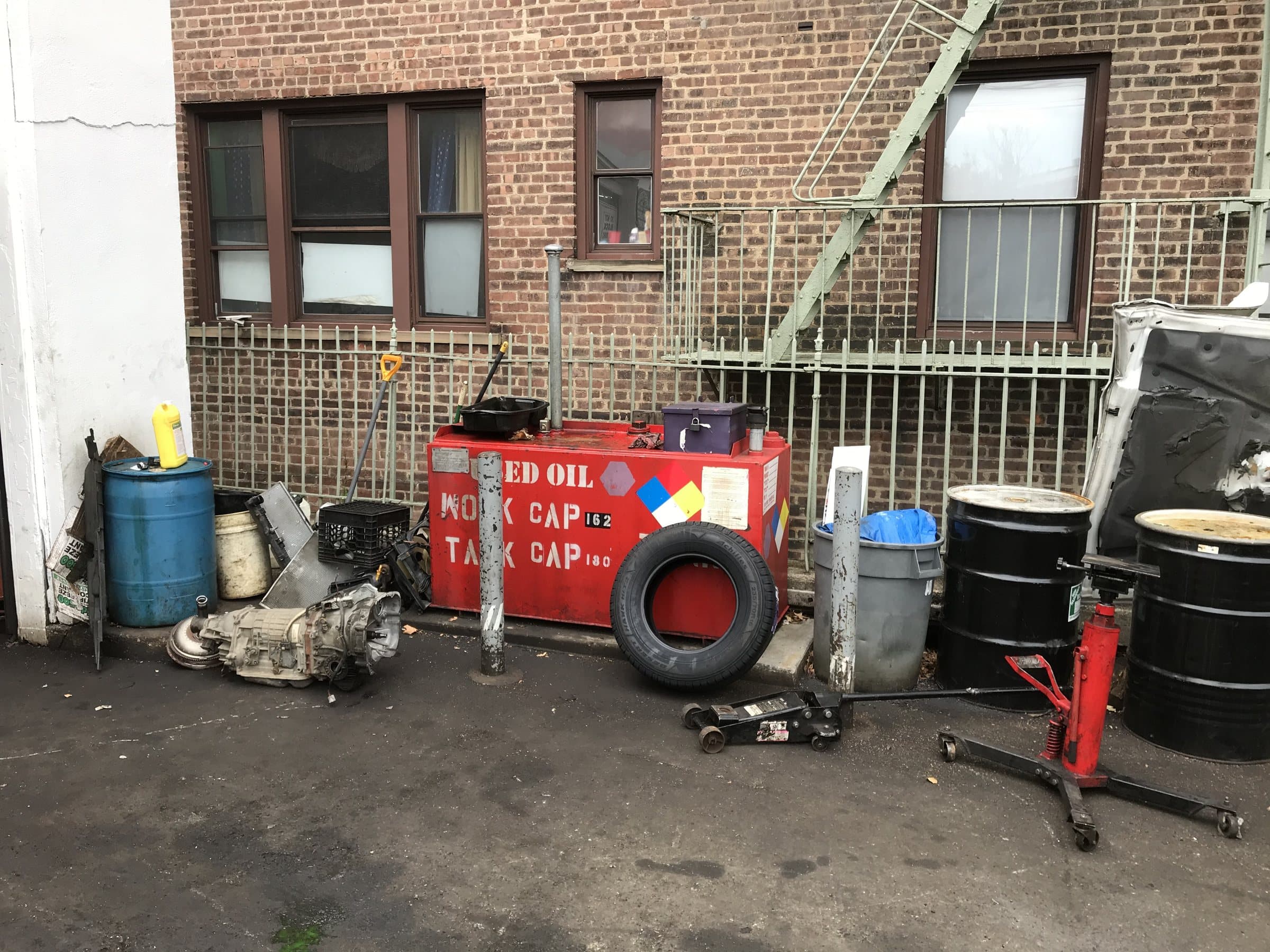 Existing oil tank and surrounding equipment at a service facility.