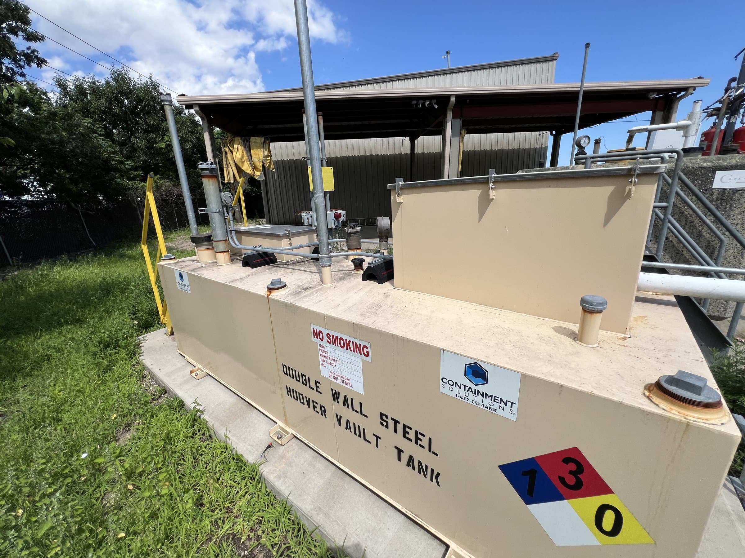 Aboveground fuel tank beside a fleet facility.