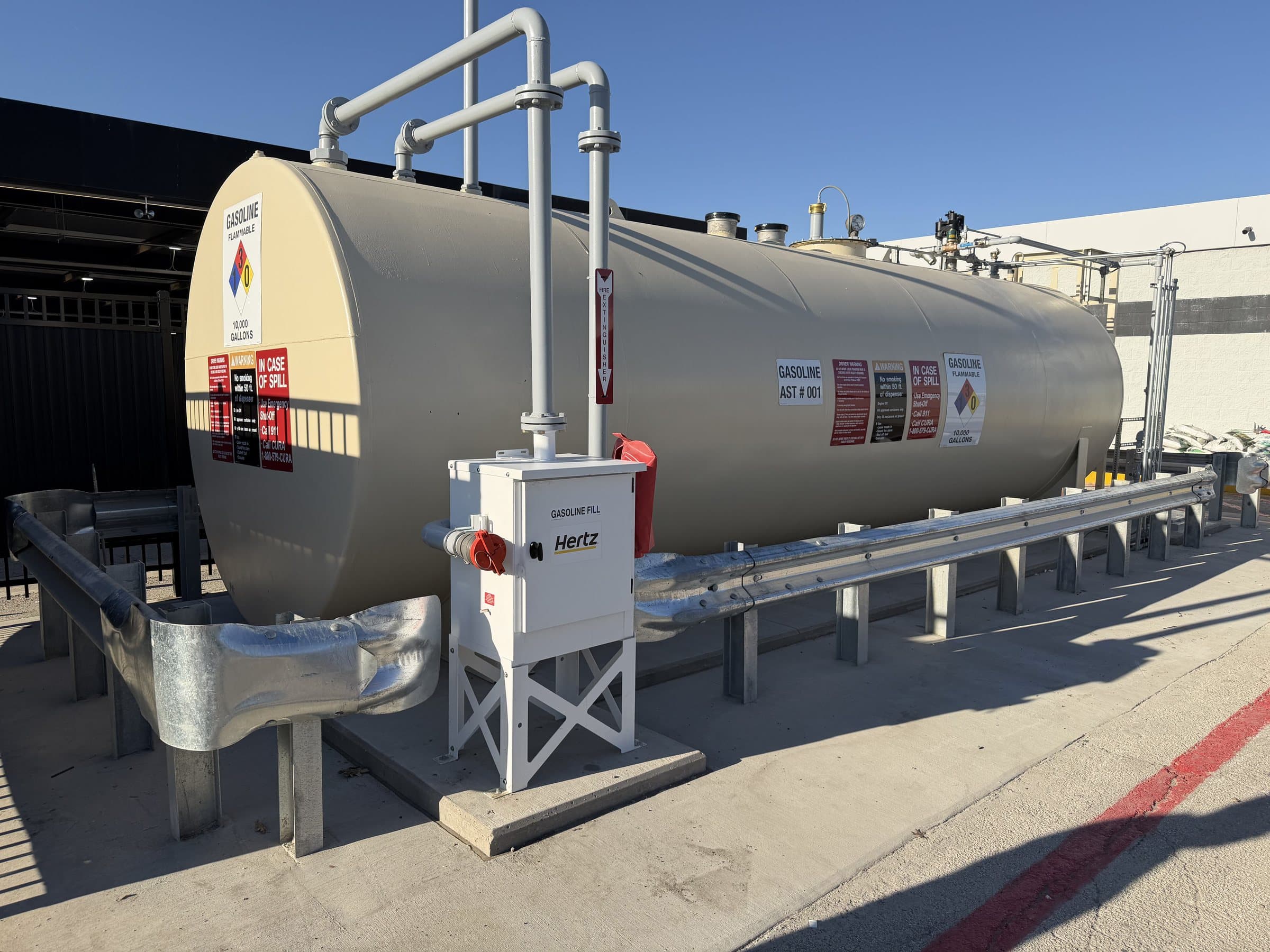Aboveground fuel tank with piping and access equipment.