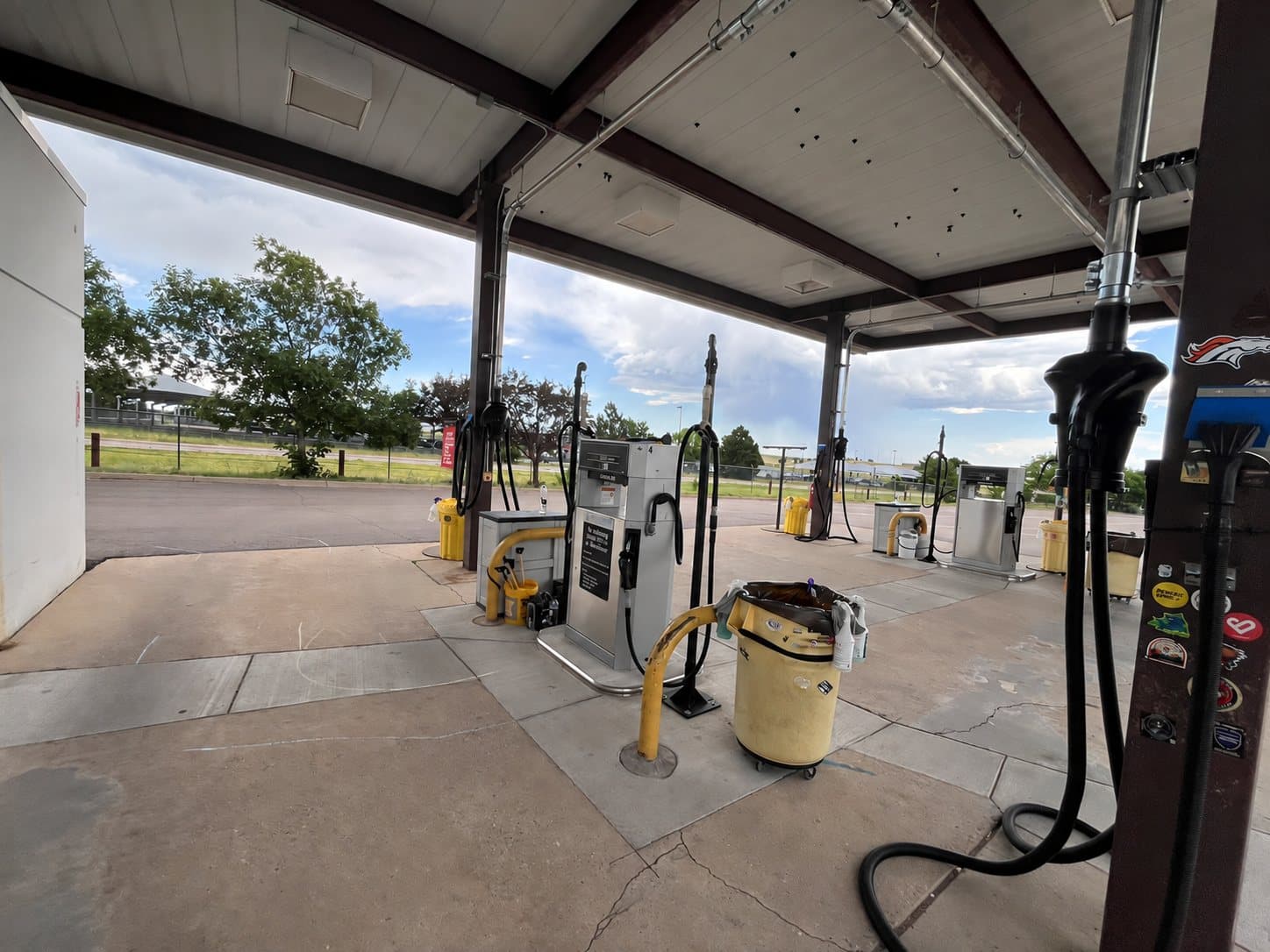 Fuel dispensers and overhead hoses at a Colorado Springs fleet fueling facility.