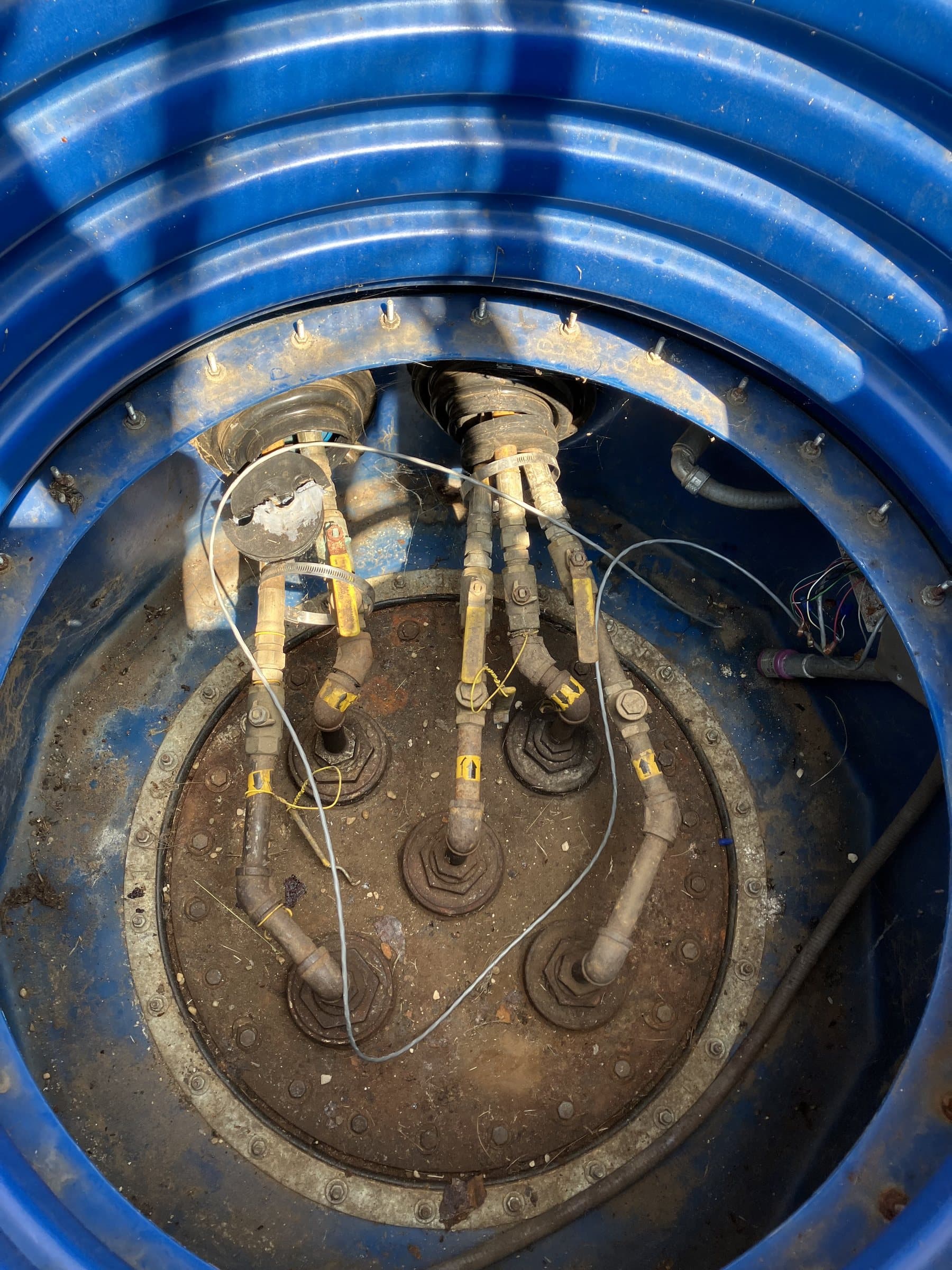 Open tank sump showing piping connections and monitoring equipment.
