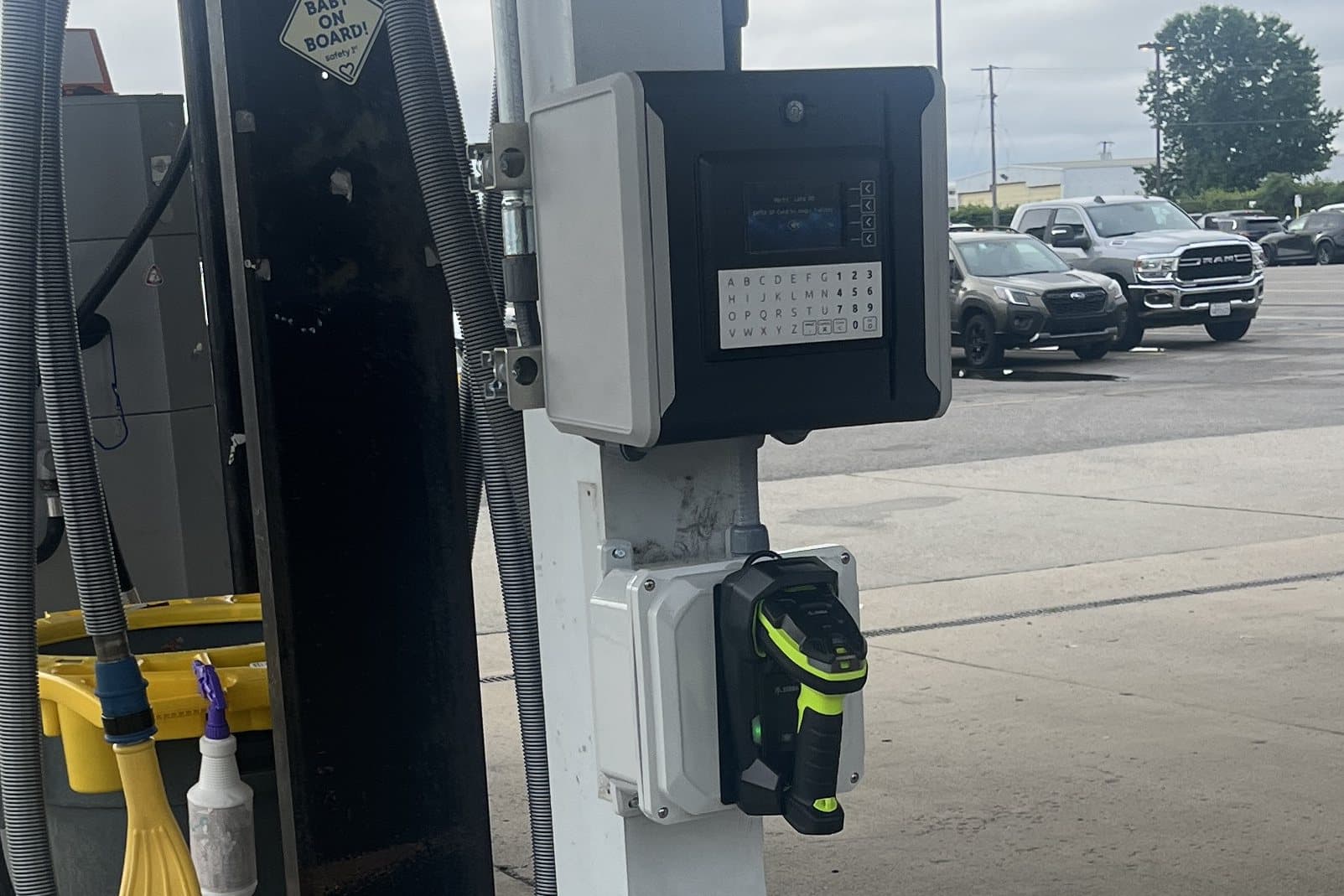 Fuel-management keypad and reader beside a dispenser.