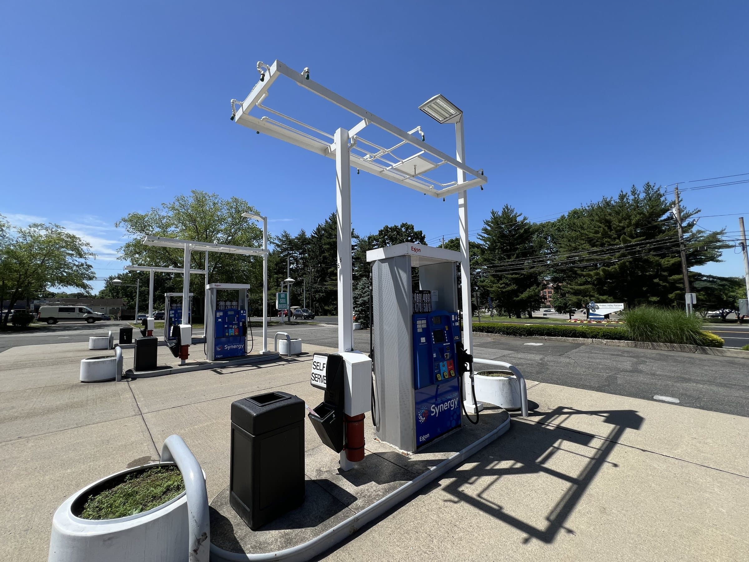 Fuel dispenser, hose and overhead equipment at a fueling island.