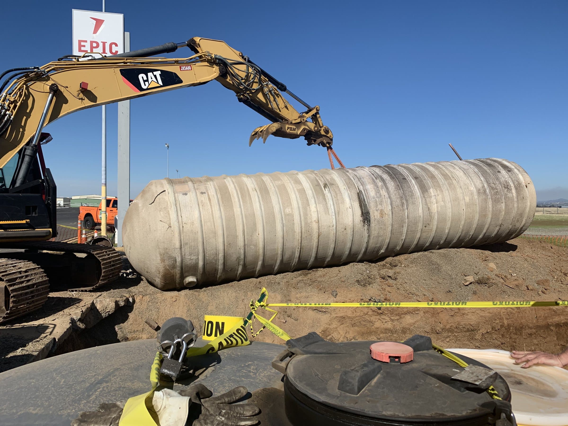 Excavator and removed underground storage tank at a fuel site.